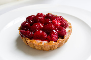 pancake tartlet dessert cake with fresh red sweet berries raspberry on white plate background
