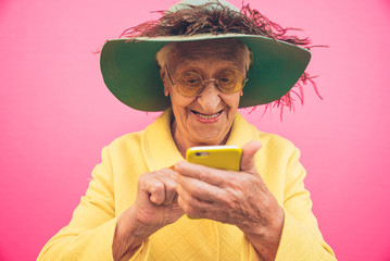 Funny grandmother portraits. Senior old woman, interacting with a smartphone. Concept about...