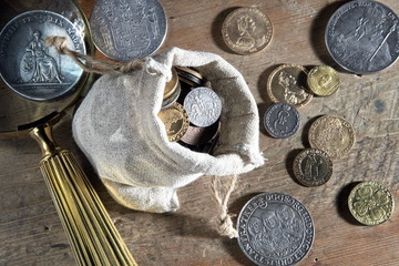 Old antique coins and medals .Bonistics and numismatics collection.Magnifying glass.Russian Empire and world old money.Silver,gold.Treasure hood concept. Vintage and retro style.