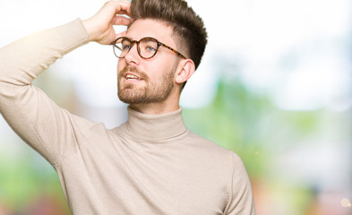 Young handsome business man wearing glasses Smiling confident touching hair with hand up gesture, posing attractive