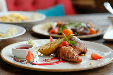 Delicious dish with pear, strawberries sauce.