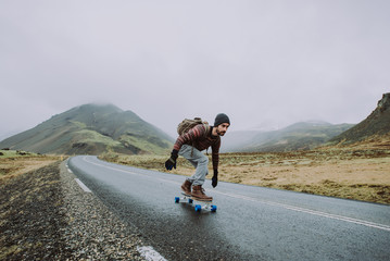 Skater traveling iceland on his longboard