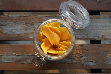 Dehydrated Mango or Dried Mango slices on wooden table         