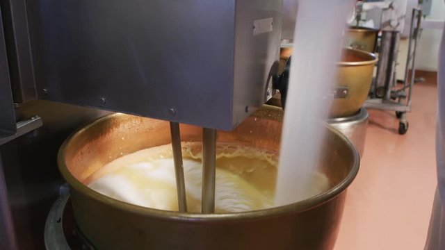 Mixing ingredients for chocolate fudge at candy factory