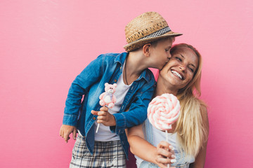 Beautiful mother and son on colored backgrounds