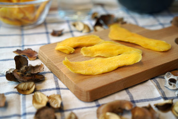 Dehydrated Mango or Dried Mango slices on wooden table   