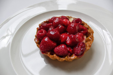 sweet delicious fresh baked dessert with berries on white plate 