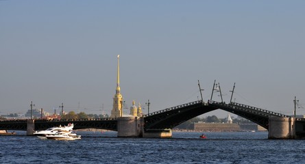 Fototapeta na wymiar motor boats near drawbridge in river Neva, Saint-Petersburg, Russia Peter-Pavel's Fortress
