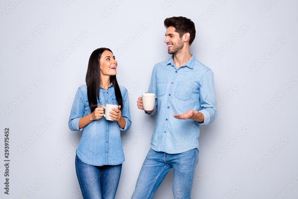 Wall mural Photo of two amazing colleagues working together spend coffee break chatting holding hot beverage wear casual jeans clothes isolated grey color background