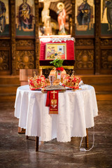 Two crowns for a orthodox wedding ceremony , the bible and a glass of red wie