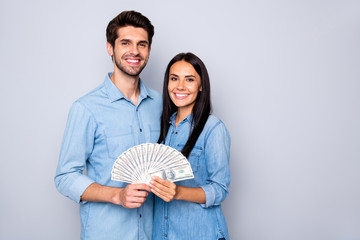 Photo of charming cute nice two people together holding their earned money wearing jeans denim...