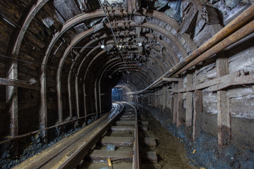 Fototapeta na wymiar Gold mine ore shaft tunnel with rails