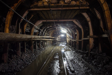 Gold mine ore shaft tunnel with rails