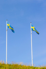 Swedish flags against a blue sky