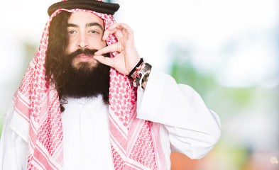 Arabian business man with long hair wearing traditional keffiyeh scarf mouth and lips shut as zip...