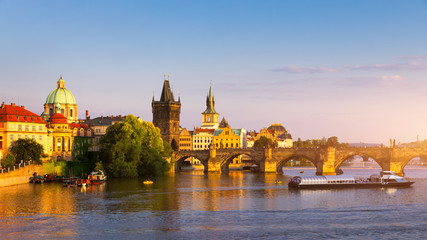 Scenic view of the Old Town pier architecture and Charles Bridge over Vltava river in Prague, Czech Republic. Prague iconic Charles Bridge (Karluv Most) and Old Town Bridge Tower at sunset, Czechia.