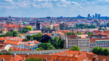 Naklejka na ściany i meble Prague red roofs and dozen spires of historical Old Town of Prague. Cityscape of Prague on a sunny day. Red rooftops, spires and the Charles Bridge and Vltava River in the background. Prague, Czechia.