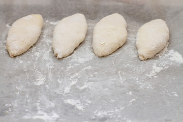 fresh pies on a baking sheet with flour