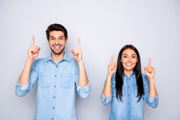 Portrait of his he her she nice attractive charming glad cheerful cheery confident couple wearing casual pointing forefingers up copy space isolated over light white gray pastel color background