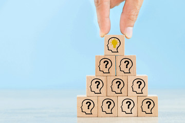 Hand arranging wood block with icon head human symbol and light bulb,concept creative idea and...