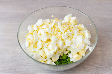 pie filling in a bowl, chopped onion and egg on table