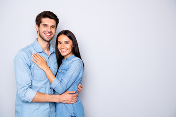 Portrait of his he her she nice attractive charming lovely cheerful cheery glad couple wearing casual embracing copy space isolated over light white gray pastel color background