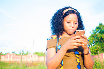excited black african girl checking interesting content online.  surprised  hipster using her...