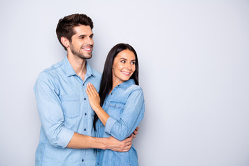 Photo of charming cheerful cute nice couple of people looking away at empty blank space wearing...