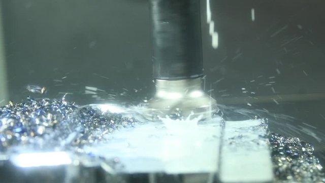 CNC milling machine work. Coolant and lubrication in gear metalwork industry