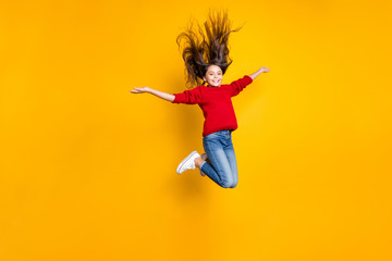 Full size photo of excited pretty little lady jumping high hairdo flying air amazing weekend mood...
