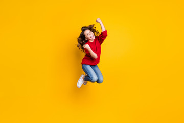 Full length photo of funny little lady jumping high celebrating newyear toys sale prices shopping wear red knitted pullover isolated yellow background