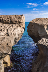 A huge rock on the shore in the form of an arch