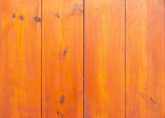 Obraz premium Wooden background of red-brown boards. Table made of natural boards covered with stain and varnish.