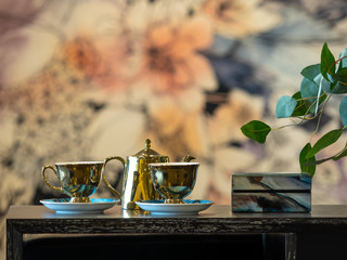 Gold tea set on cabinet