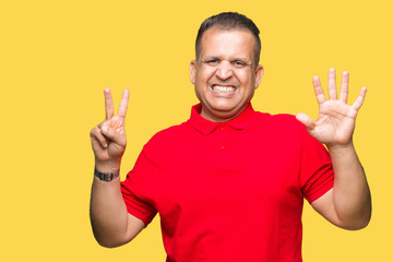 Middle age arab man over isolated background showing and pointing up with fingers number seven while smiling confident and happy.