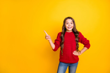 Portrait of funny funky cheerful kid promoter point index finger recommend choose decide advise tips select suggest ads wear stylish clothes denim jeans isolated over yellow color background