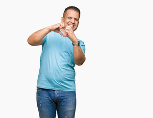 Fototapeta premium Middle age arab man wearing blue t-shirt over isolated background smiling in love showing heart symbol and shape with hands. Romantic concept.