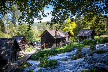 Fototapeta na wymiar Old small wooden water mills called Mlincici by the Pliva lakes near the Jajce town in Bosnia and Herzegovina