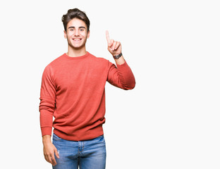 Young handsome man over isolated background showing and pointing up with finger number one while smiling confident and happy.