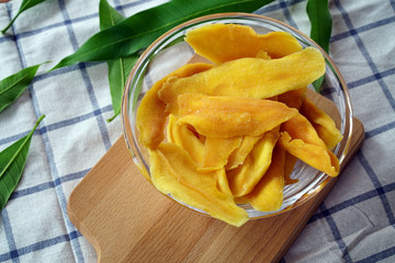 Dehydrated Mango Slices in Glass Bowl with mango leaf 