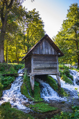Old small wooden water mills called Mlincici by the Pliva lakes near the Jajce town in Bosnia and Herzegovina