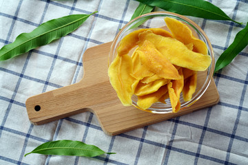 Dehydrated Mango Slices in Glass Bowl with mango lea