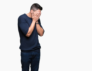 Young handsome man wearing sweater over isolated background with sad expression covering face with hands while crying. Depression concept.