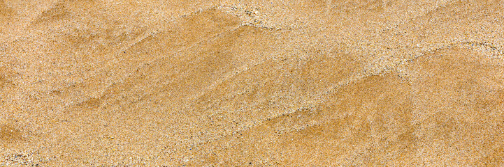 Sand surface and background. Sand Texture. Brown sand. Background from fine sand. Sand background. Closeup of sand pattern of a beach in the summer.