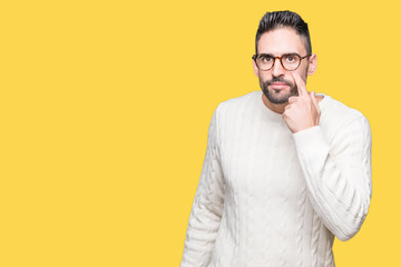 Young handsome man wearing glasses over isolated background Pointing to the eye watching you gesture, suspicious expression