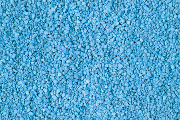 Fertilizer texture close up. Blue background. Dark blue phosphate fertilizer background. Blue granular fertilizer texture.