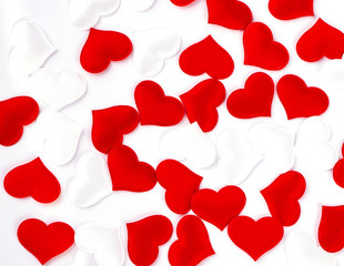 The Red and white hearts on white textured fabric background