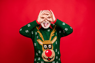 Portrait of funky funny old man grey hair enjoy christmas theme party make binoculars with his...
