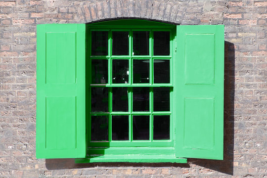 Window in old English warehouse building painted neo mint