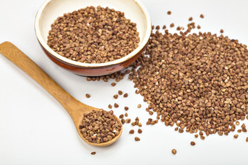 buckwheat in a plate and in a wooden spoon